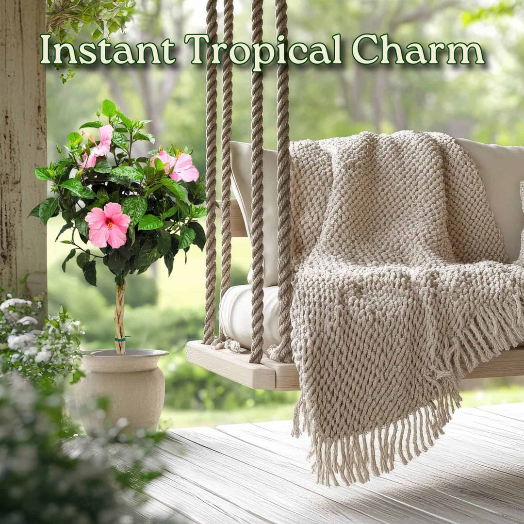 Tropical-themed swing with pink flowers and a blanket on a wooden deck #trunk_braided