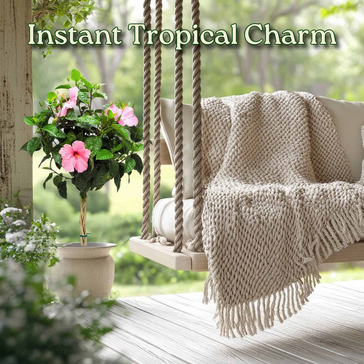 Tropical-themed swing with pink flowers and a blanket on a wooden deck #trunk_braided